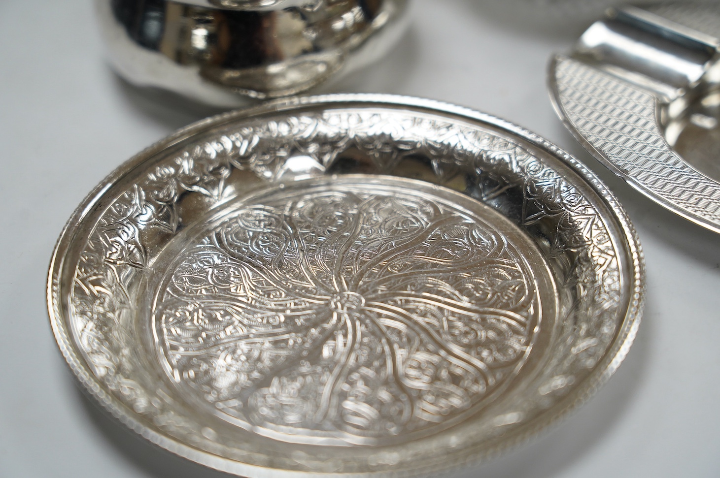 Sundry small silver and white metal items including silver tea strainer on stand and ashtray, pierced silver bowl, sterling dishes and dwarf candlesticks, etc. Condition - poor to fair